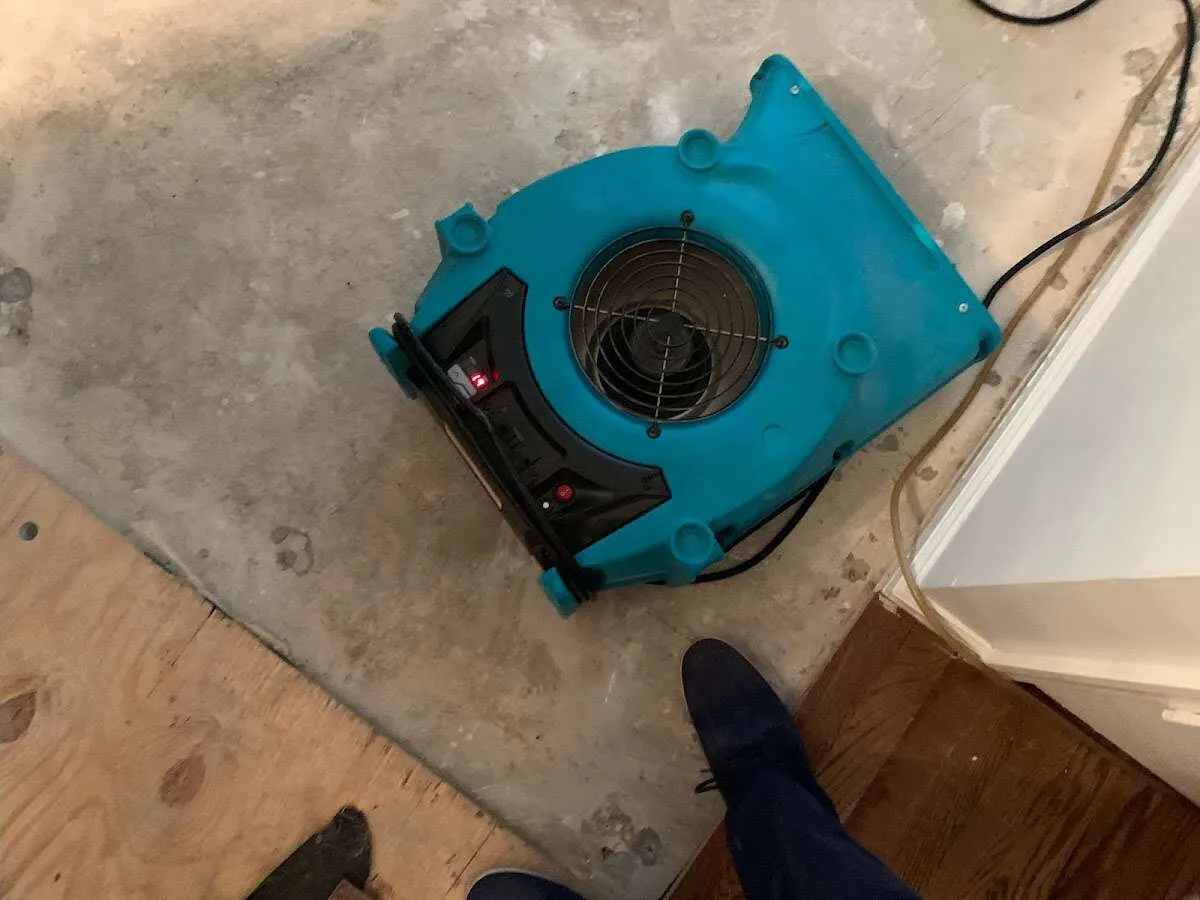 Air mover drying subfloor during Leak Detection & Repair in Shakopee